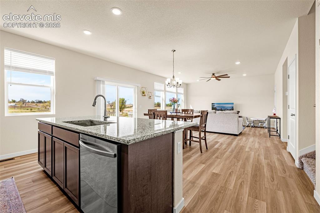 Image 12 of 50: Kitchen island with integrated sink and dishwasher, granite countertop, woo