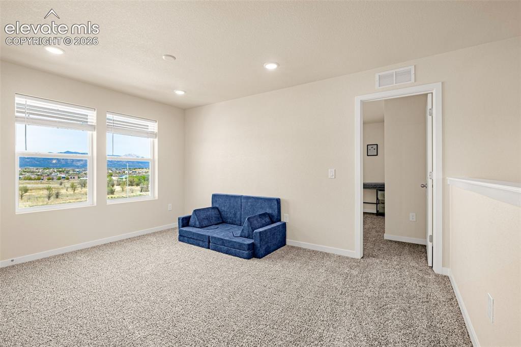 Image 15 of 50: Recessed lighting illuminates the carpeted interior, featuring multiple win