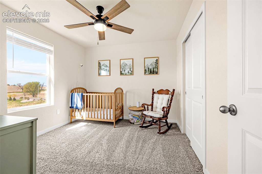 Image 21 of 50: Recessed lighting, wood-finish ceiling fan, large window with blinds, light