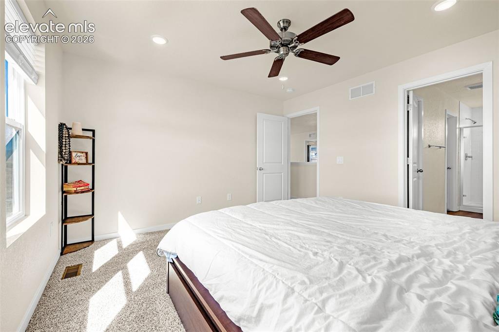 Image 24 of 50: Light-colored walls with recessed lighting, brown ceiling fan, and carpeted