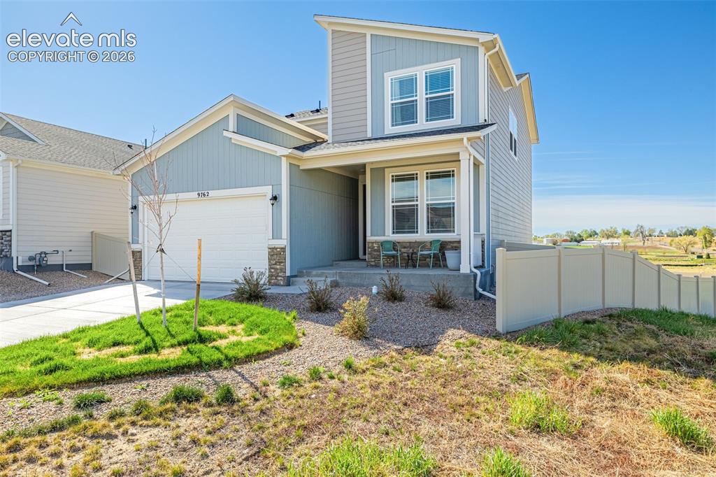 Image 34 of 50: Contemporary exterior featuring light blue siding, stone veneer accents, an