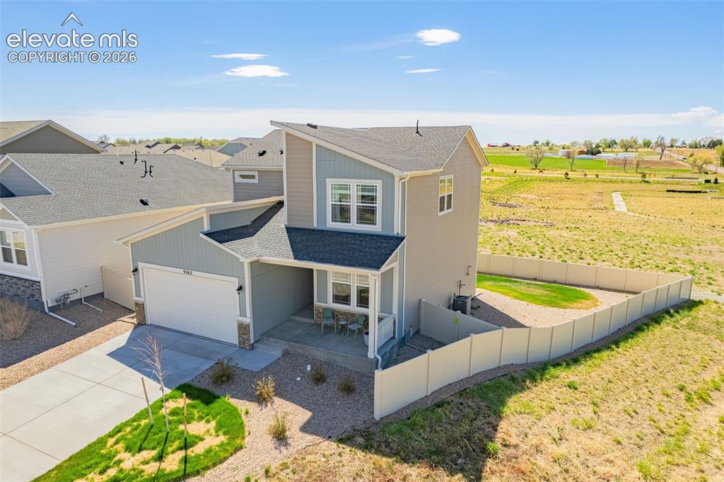 Image 36 of 50: Modern architectural style, two-story residence with a covered front porch,