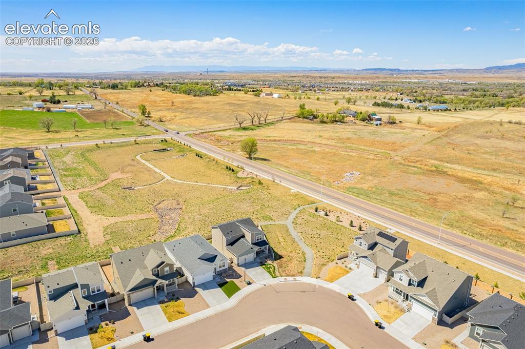 Image 49 of 50: Residential neighborhood with cul-de-sac, adjacent to open fields and a pav