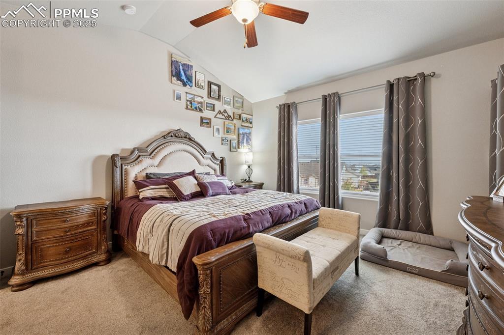 Image 16 of 40: Large primary suite with ceiling fan and great views. Main floor location.