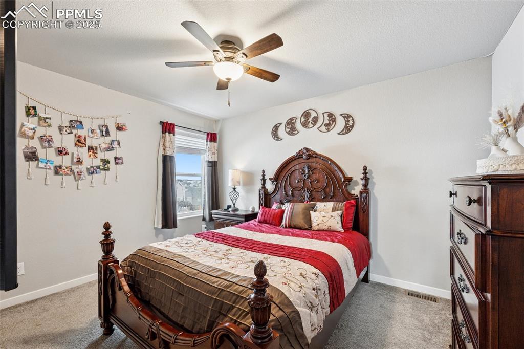 Image 20 of 40: Carpeted bedroom featuring baseboards and ceiling fan