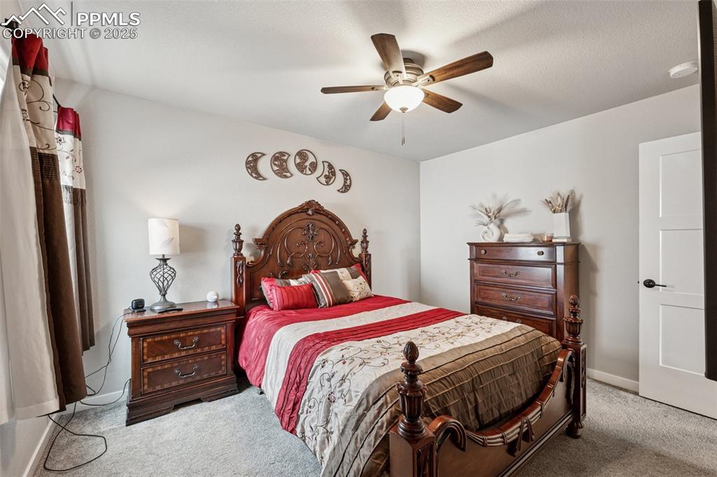 Image 21 of 40: Carpeted bedroom featuring a ceiling fan and baseboards