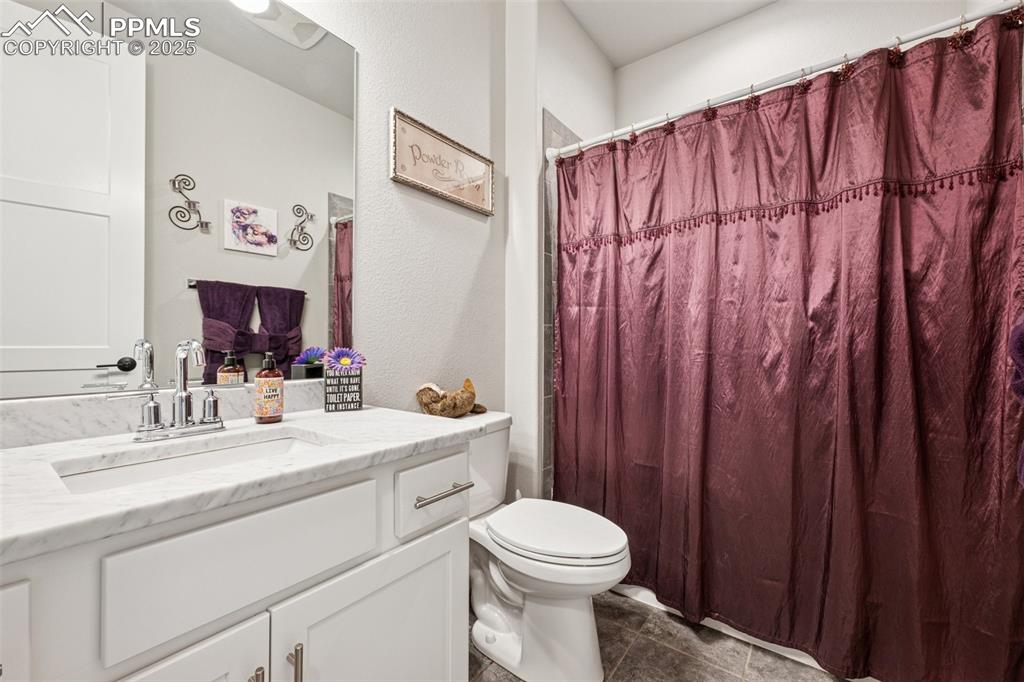 Image 22 of 40: Bathroom featuring vanity, a shower with shower curtain, a textured wall, a