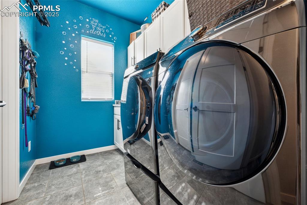 Image 23 of 40: Laundry room featuring cabinet space, sink, washer/dryer included; all on t