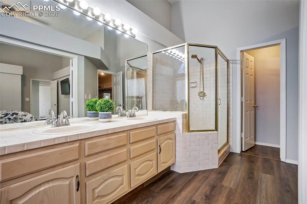 Image 21 of 43: Bathroom featuring a shower, double vanity, and jet tub