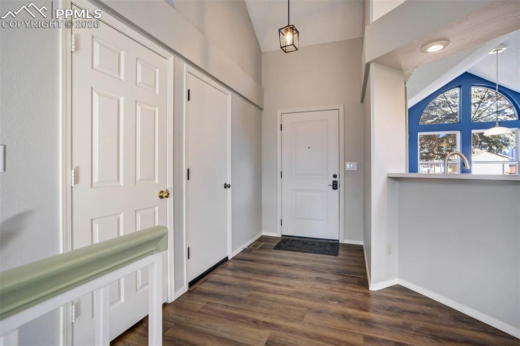 Image 5 of 43: Entrance foyer with vaulted ceiling and dark wood finished floors
