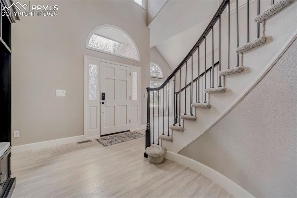 Image 12 of 30: Foyer with grand staircase