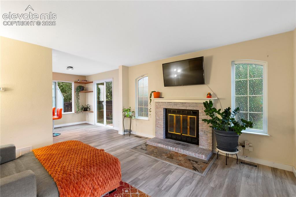 Image 5 of 15: Awesome wood burning fireplace in living room