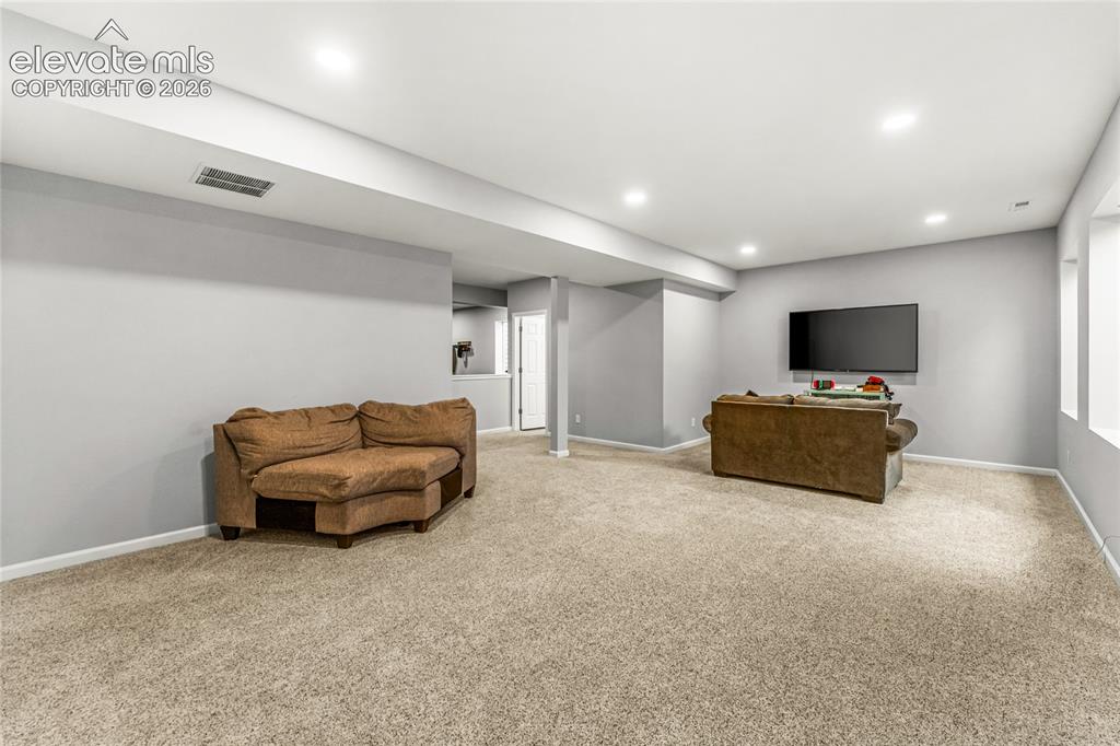 Image 26 of 32: Dedicated laundry area featuring wood-finish flooring, a single window, and