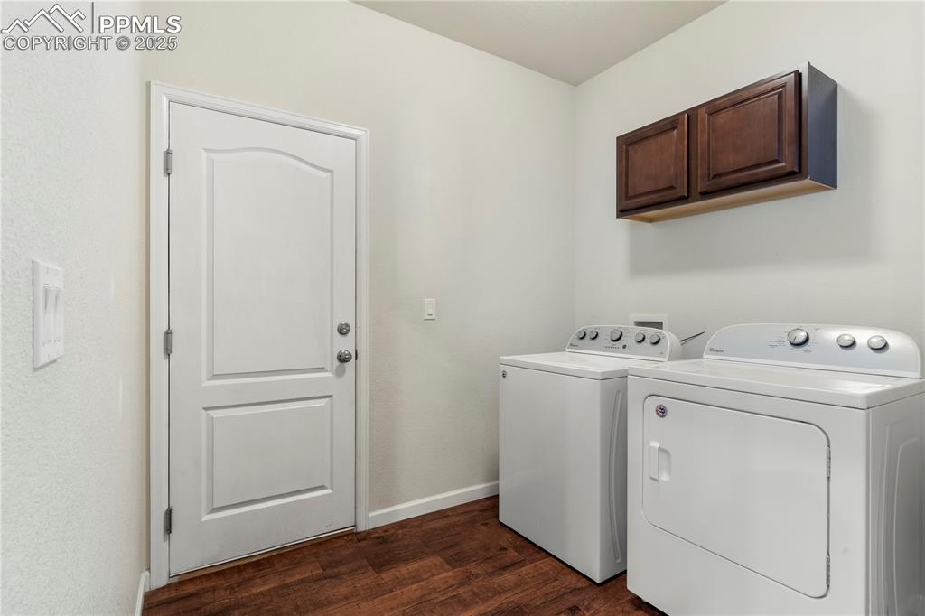 Image 17 of 35: Washing Machine and Dryer included. Laundry room with cabinet space, dark w