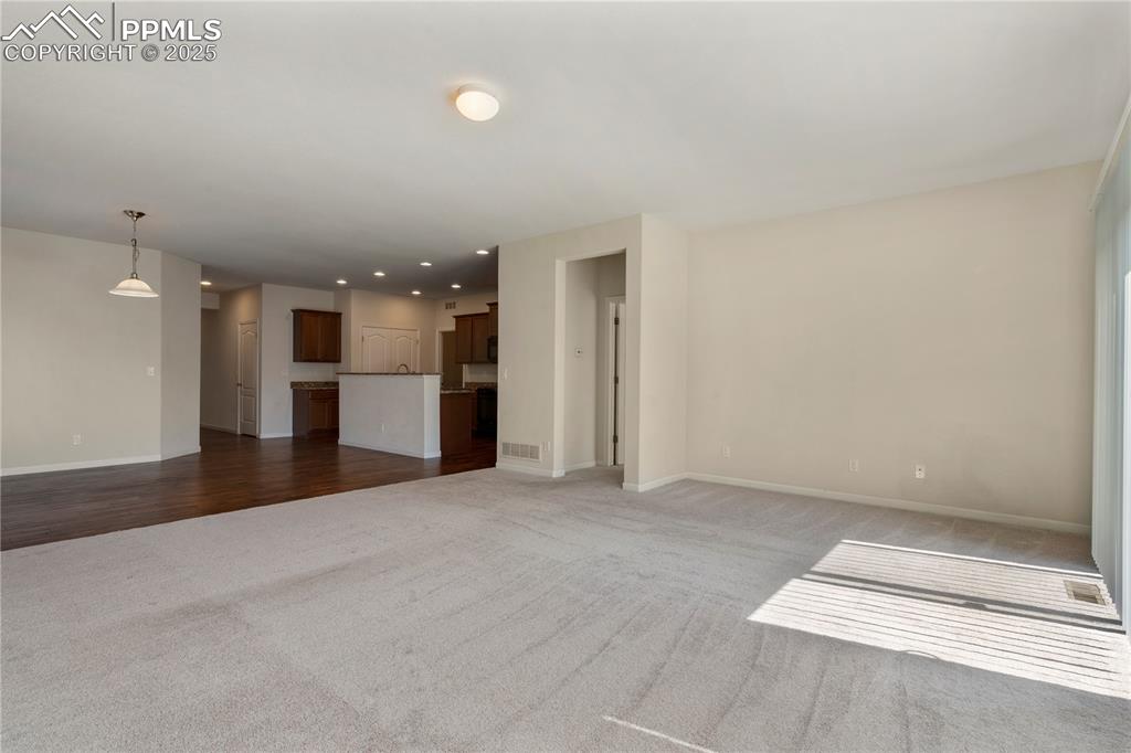 Image 20 of 35: Open Concept living room featuring carpet floors, baseboards, and recessed