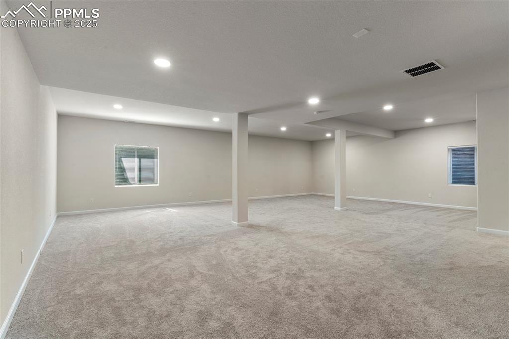 Image 25 of 35: Below grade area with light carpet, baseboards, and recessed lighting