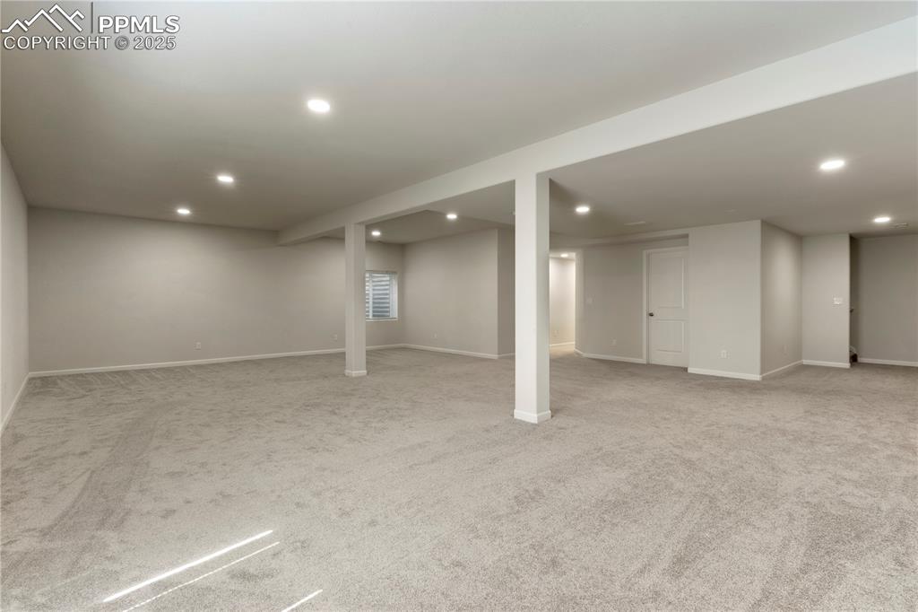 Image 26 of 35: Finished basement with recessed lighting, carpet flooring, and baseboards