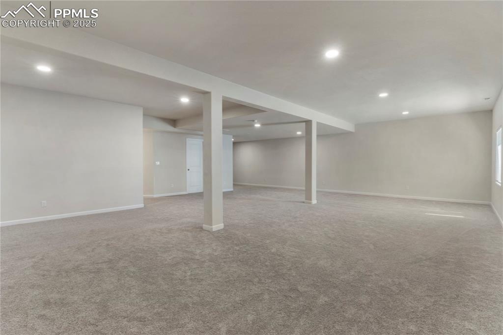 Image 27 of 35: Finished basement featuring recessed lighting, light carpet, and baseboards