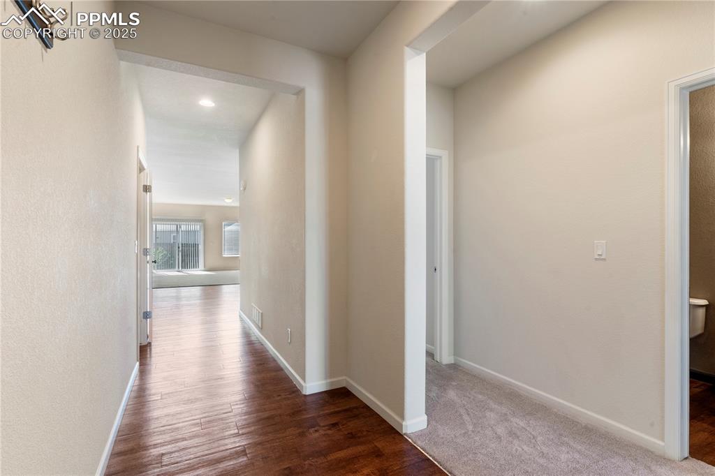 Image 5 of 35: Hallway featuring wood finished floors and baseboards