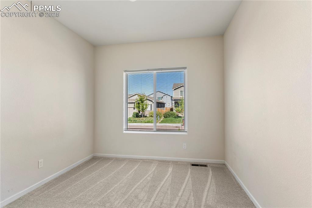 Image 6 of 35: Unfurnished bedroom with light carpet, baseboards, and a closet