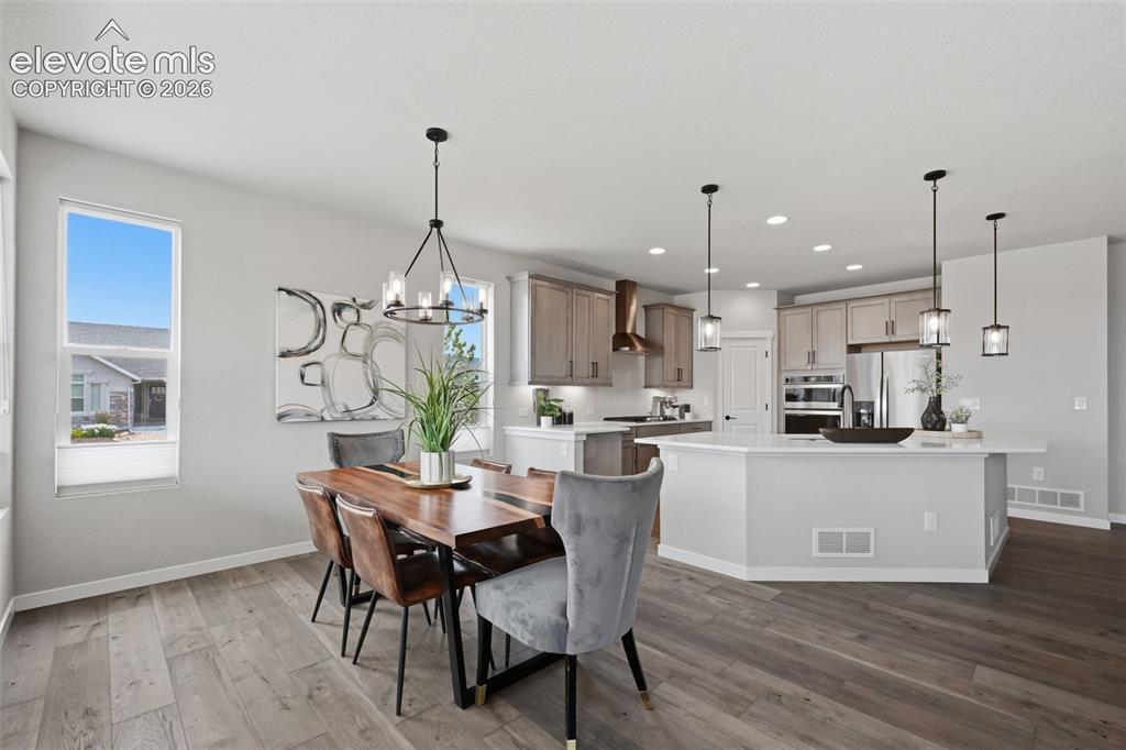 Image 12 of 33: Another view of the kitchen/dining area with upgraded lighting!
