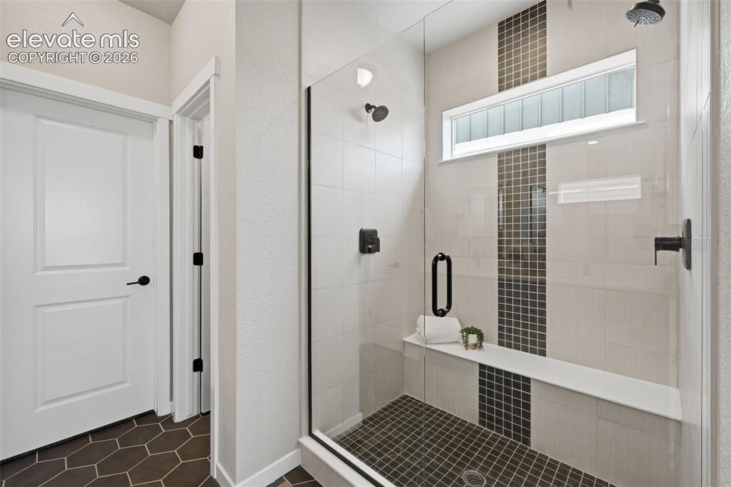 Image 16 of 33: Edgeless door and expanded shower in the spa like master shower!