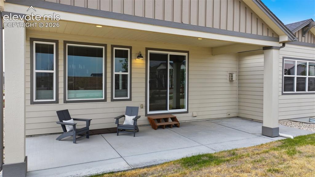 Image 30 of 33: Extended covered porch for summer entertaining!