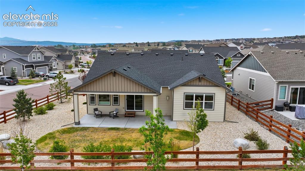 Image 31 of 33: Back yard of this wonderful home with extended covered porch!