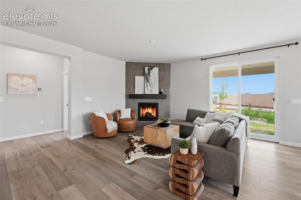Image 7 of 33: Spacious family room with corner fireplace!
