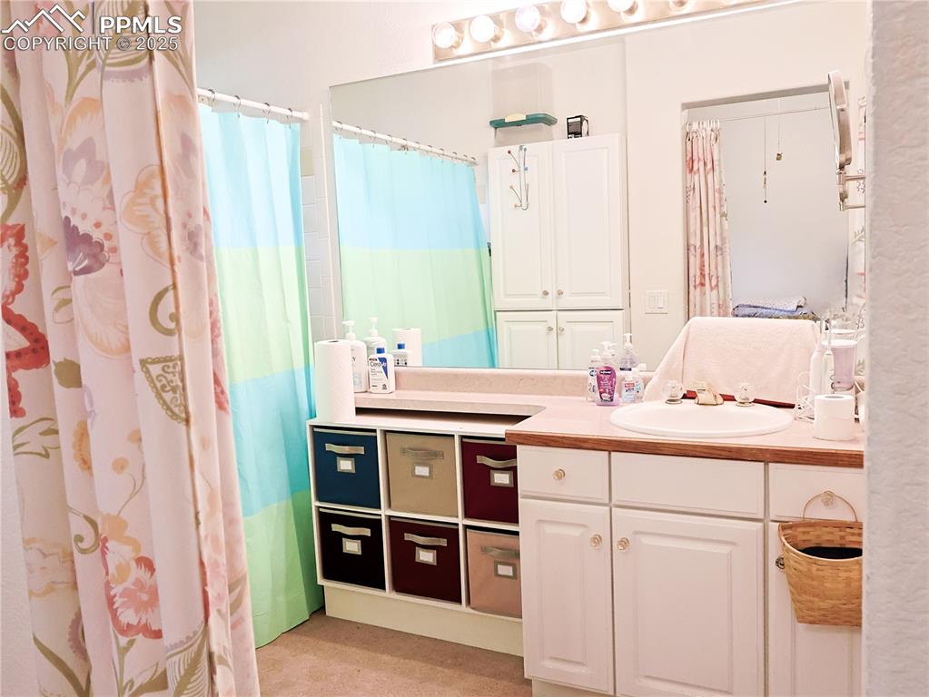 Image 12 of 29: Bathroom featuring vanity and curtained shower