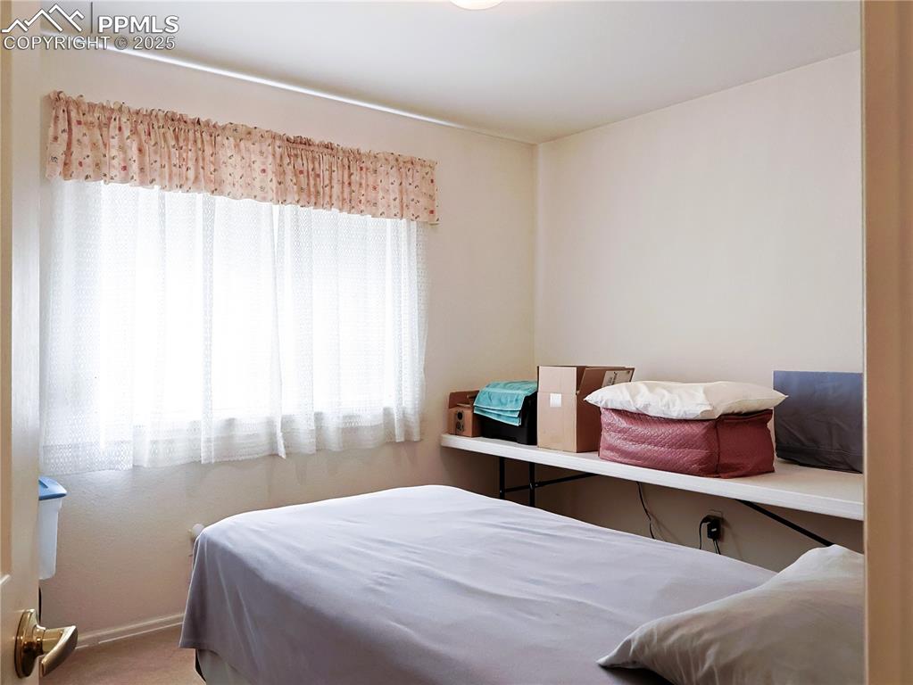Image 13 of 29: Carpeted bedroom with baseboards