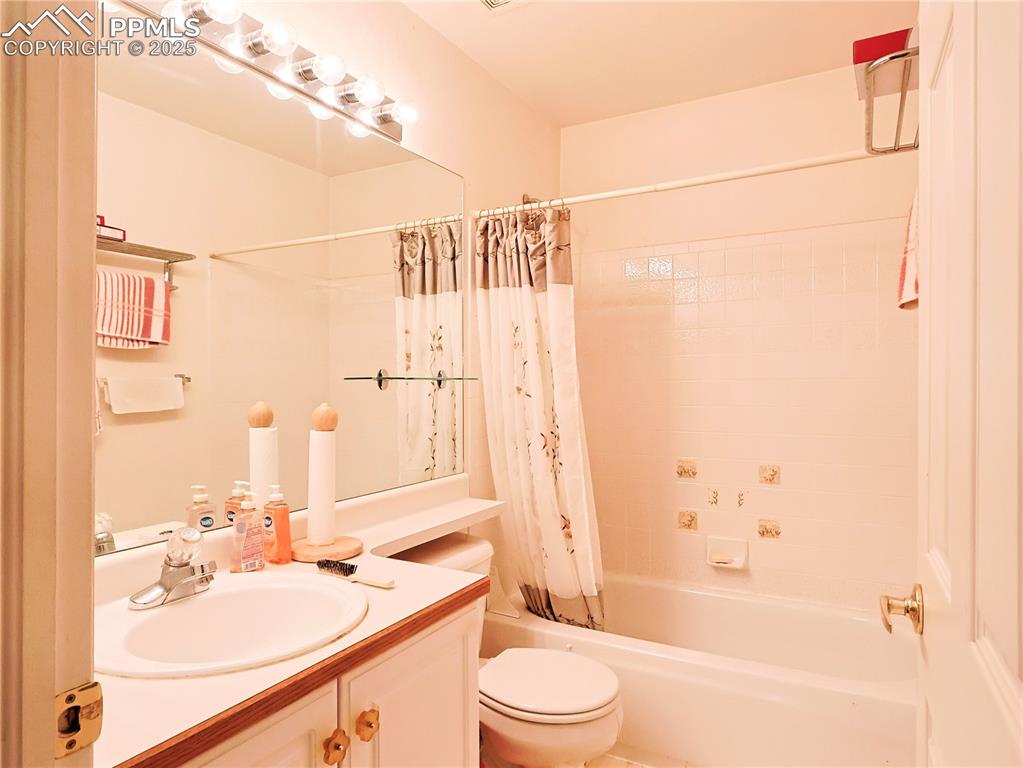 Image 14 of 29: Bathroom with shower / bath combo and vanity