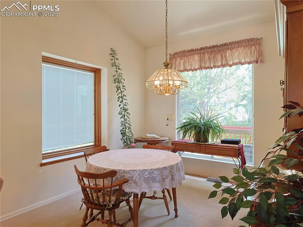 Image 4 of 29: Dining space with baseboards and carpet flooring