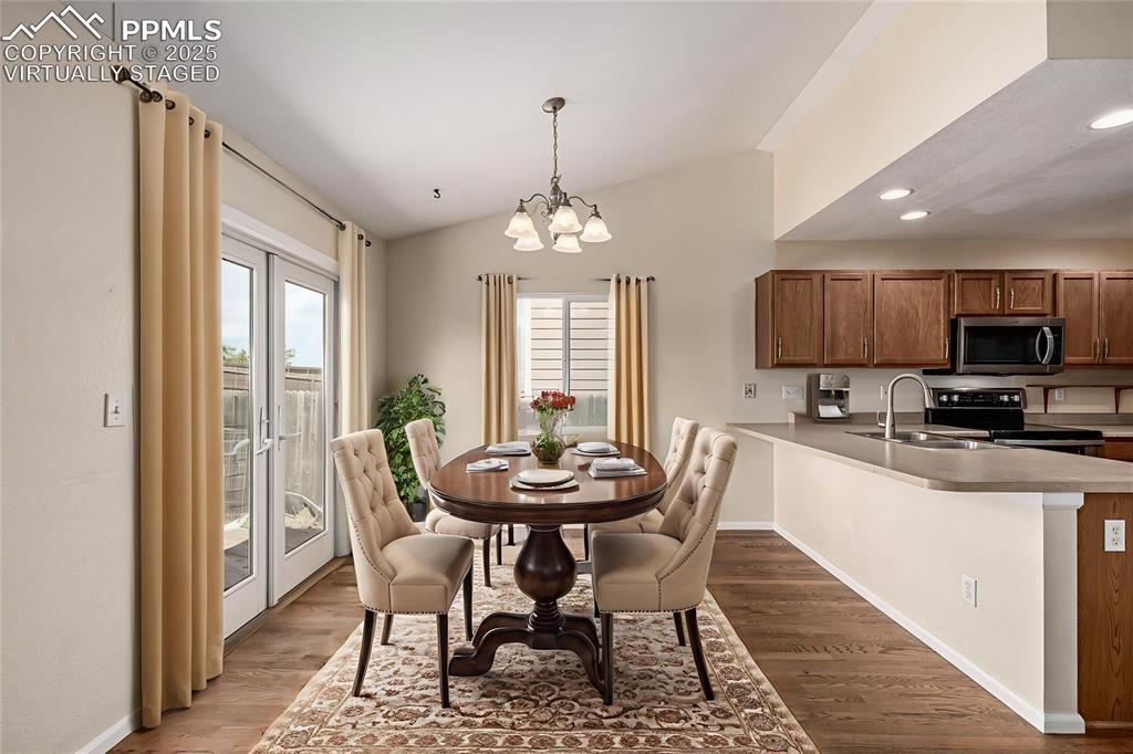 Image 11 of 26: Virtually Staged - The dining room is spacious and features French doors wi