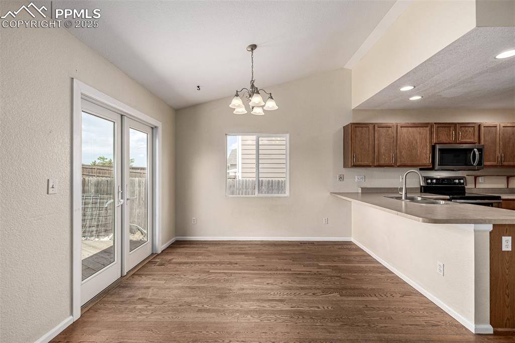 Image 12 of 26: The dining room is spacious and features French doors with natural lighting