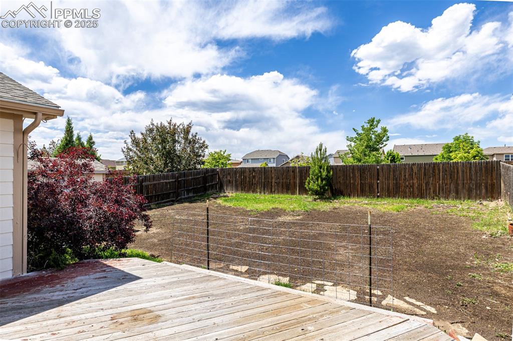 Image 22 of 26: Spacious backyard with new grass growing soon!