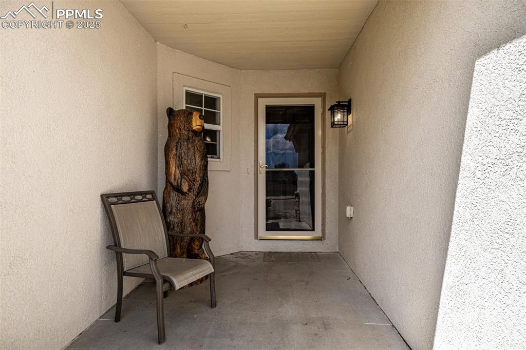 Image 3 of 26: Enjoy the summer months on this cozy front patio