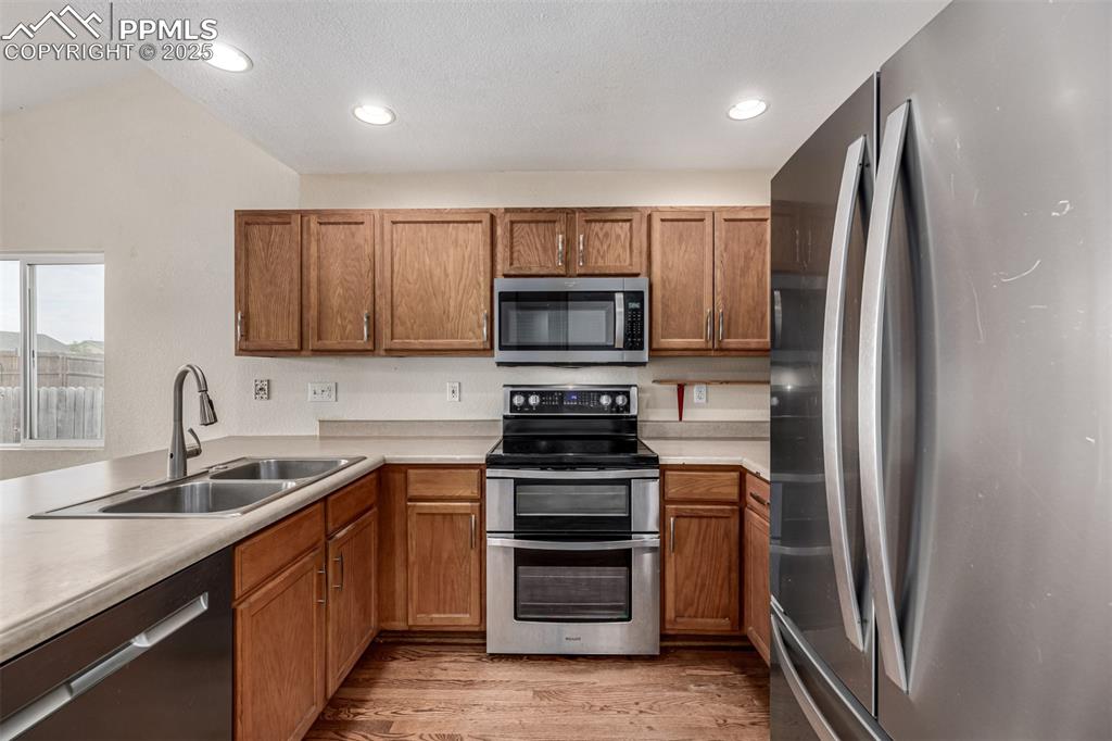 Image 9 of 26: Featuring stainless steel appliances and a double oven range