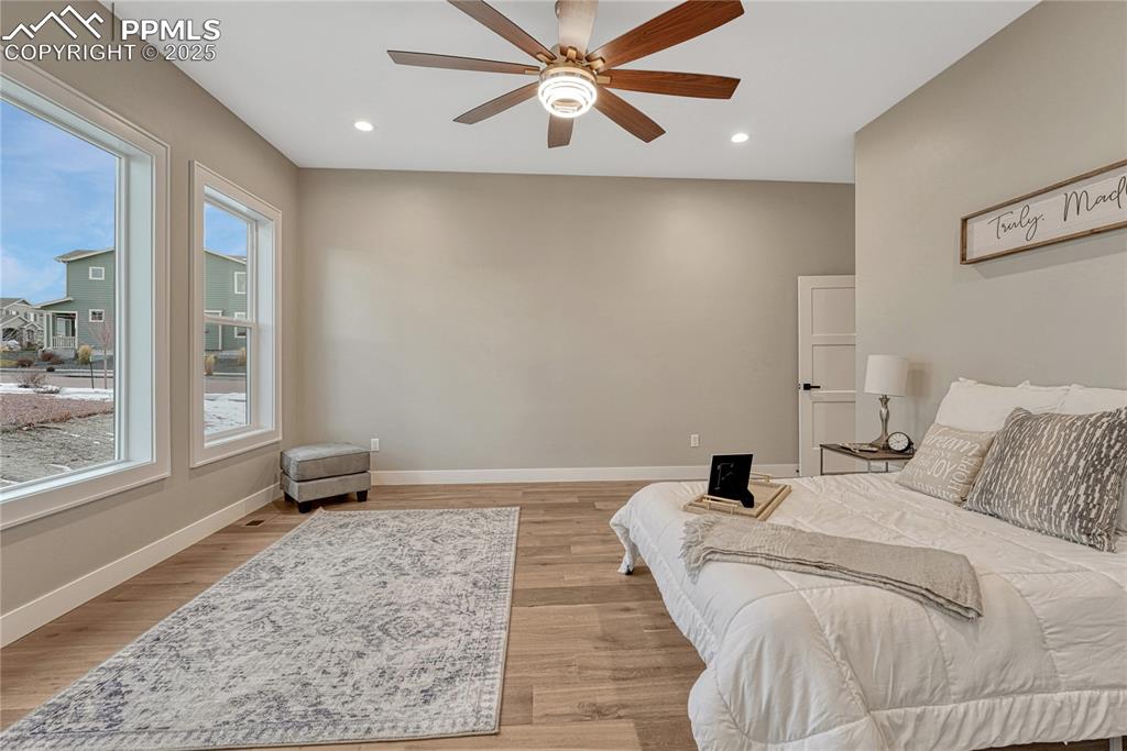 Image 19 of 50: Main Level Bedroom-Ceiling Fan and lots of natural light