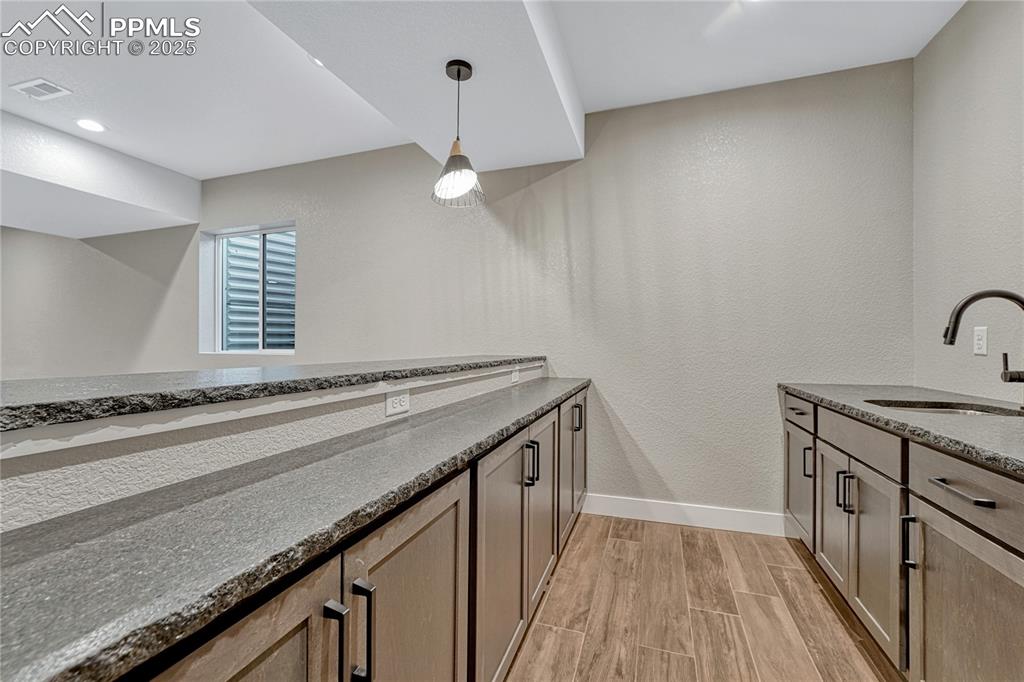 Image 34 of 50: Wet Bar-Leathered Granite Countertops