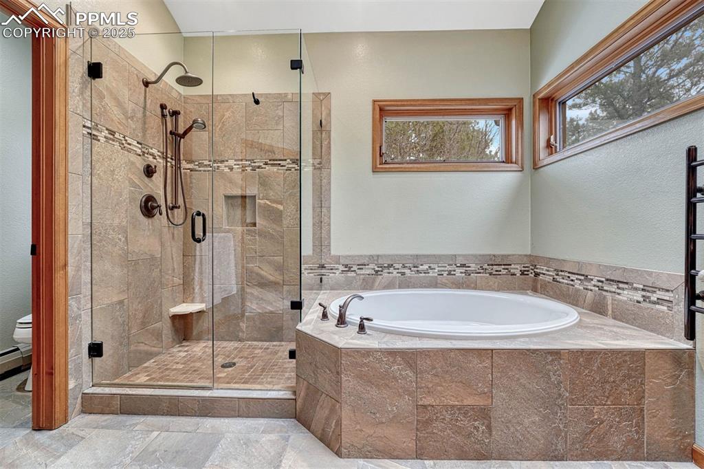 Image 20 of 46: Soaking tub & walk in shower.