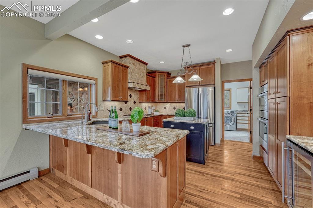 Image 8 of 46: Cherry cabinets, granite countertops and new Bosch refrigerator, wall oven,