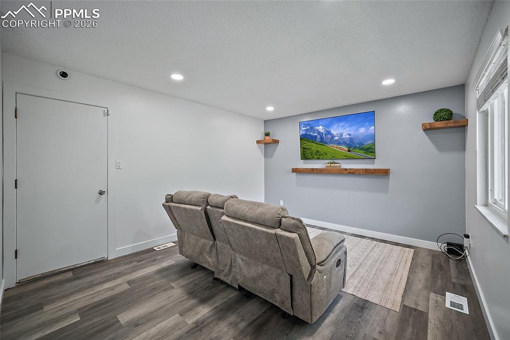 Image 14 of 38: Living room with door to the garage
