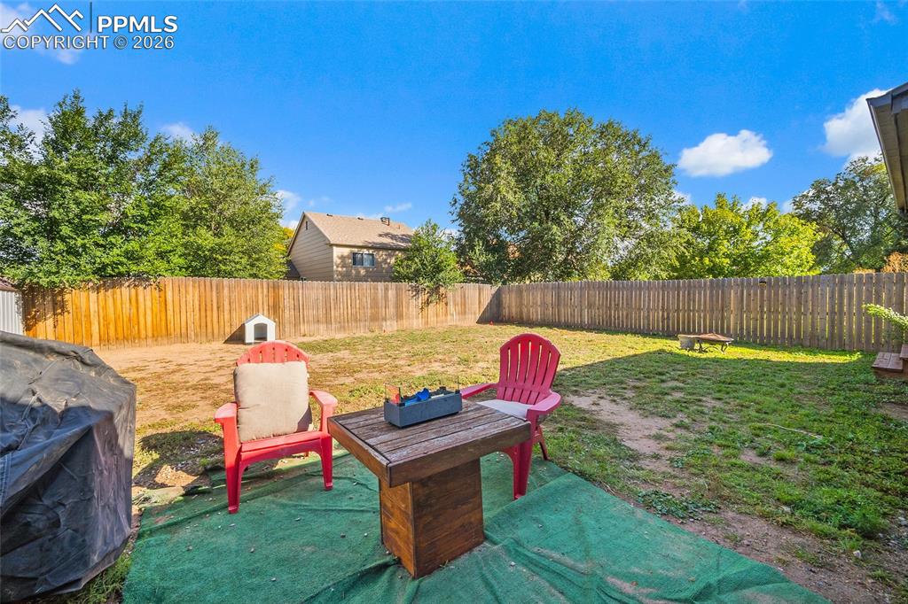 Image 28 of 38: Fenced backyard