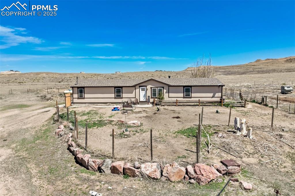 Caption: Front of property with a mountain view and fence