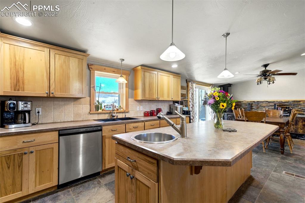 Image 11 of 50: Kitchen with a sink, dishwasher, and a wealth of natural light