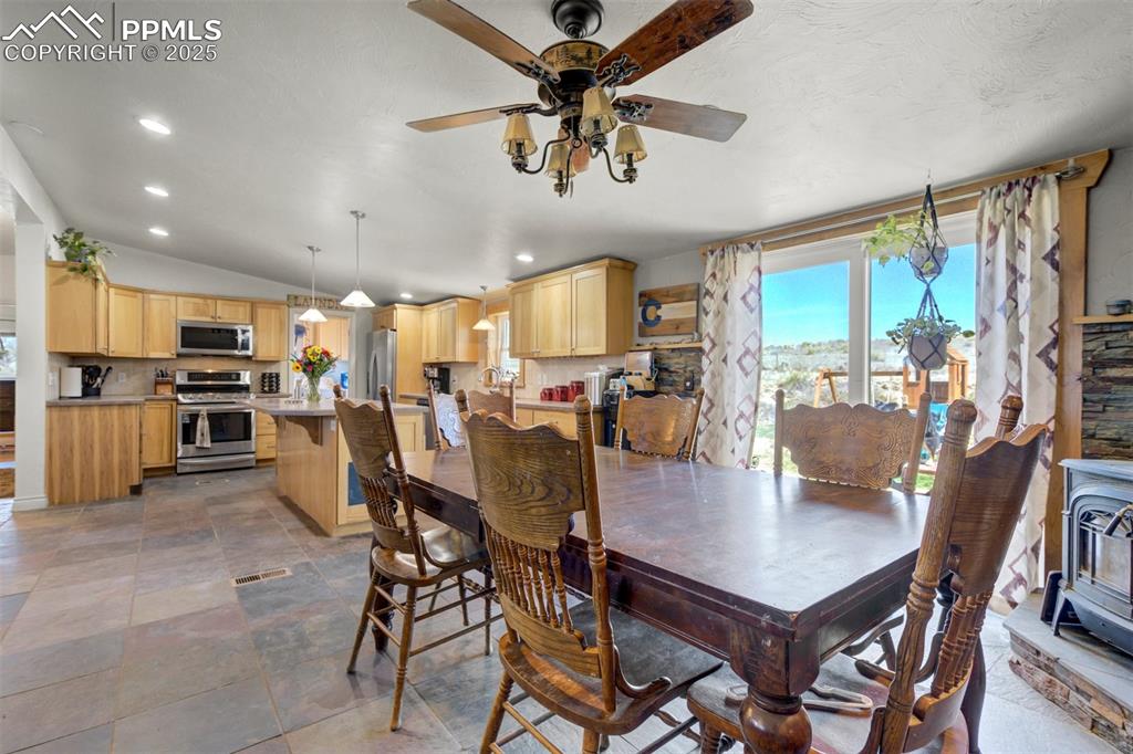 Image 17 of 50: Dining space with recessed lighting, ceiling fan, vaulted ceiling, and visi