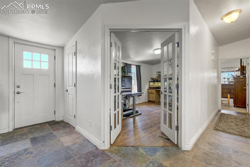 Image 18 of 50: Foyer entrance featuring baseboards and stone tile floors