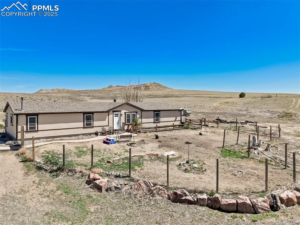 Image 2 of 50: View of front of house featuring fence and a mountain view