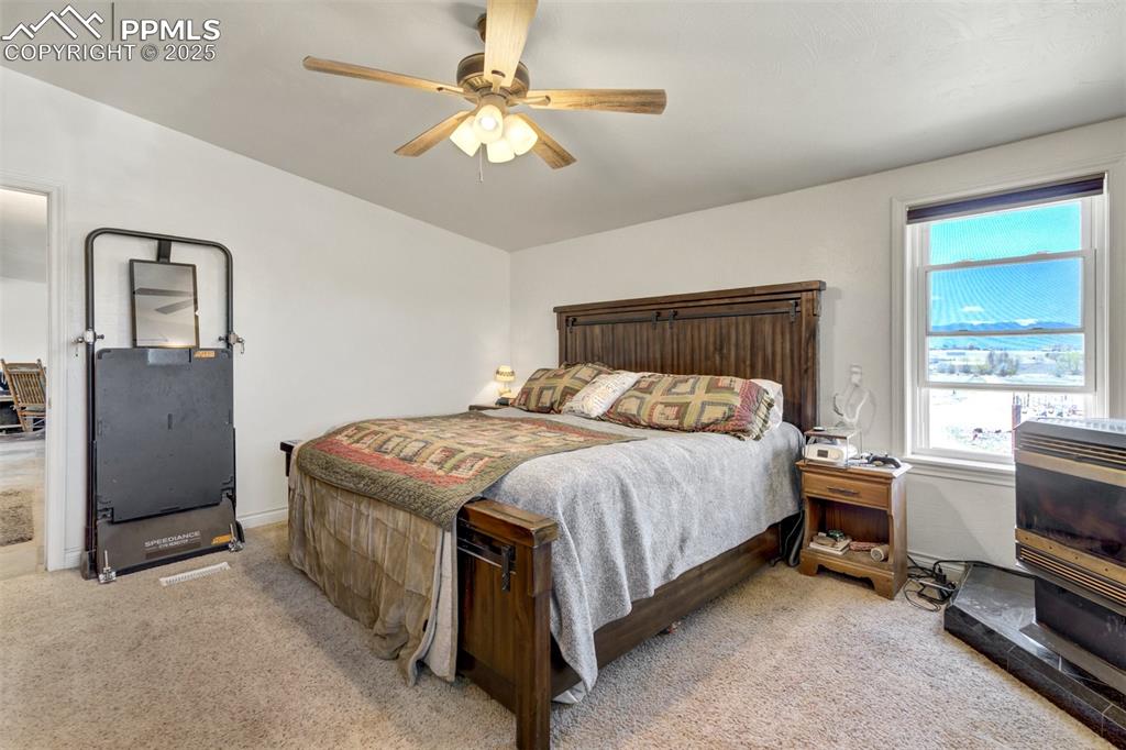 Image 24 of 50: Bedroom featuring carpet floors and ceiling fan
